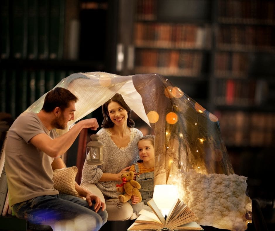 Family under a blanket fort with twinkle lights and a lantern