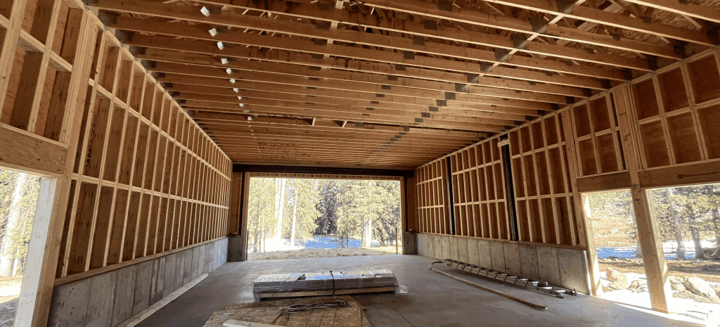 A Construction site with framed boards over a cement floor for the Skyway Station