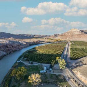Honey Rock Landing ariel view of fields, a winding river, hill and an orchard