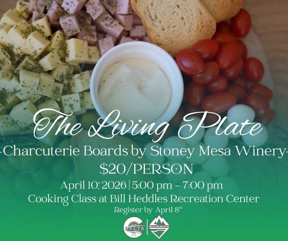 A promotional graphic for "The Living Plate," a charcuterie board cooking class by Stoney Mesa Winery. Visual Composition: Background: A top-down close-up of a vibrant charcuterie board featuring cubed cheeses topped with herbs, diced meats, toasted bread slices, cherry tomatoes, and small white mozzarella balls. A small white bowl of dip sits in the center. Text Overlays: Large elegant white script at the center reads "The Living Plate". Below this, green and white text lists the event as a cooking class at Bill Heddles Recreation Center on April 10th, 2026, with a cost of $20 per person and a registration deadline of April 8th. Logos: The City of Delta and Delta Recreation logos are featured at the bottom center.